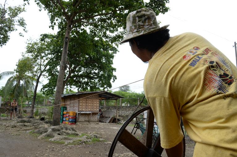 A local resident makes a rope, one of the sources of income aside from farming, in the village of Ibabao, Cebu provnce, in central Philippines, on January 21, 2014