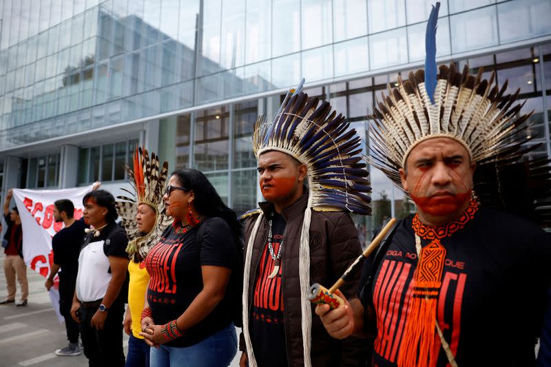 A coalition of environmental activists and Indigenous groups from Brazil protests outside the courthouse in Paris