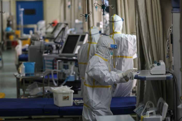 Workers disinfect equipment in coronavirus ward