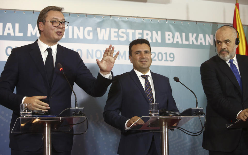 Serbia's President Aleksandar Vucic, left, talks next to North Macedonia's Prime Minister Zoran Zaev, center and Albania's Prime Minister Edi Rama, right, during a joint news conference, following the Western Balkan leaders' meeting in the southwestern town of Ohrid, North Macedonia, Sunday, Nov. 10, 2019. Western Balkan leaders say they are committed to work closely and to remove administrative barriers for free movement of goods and people between their countries. (AP Photo/Boris Grdanoski)