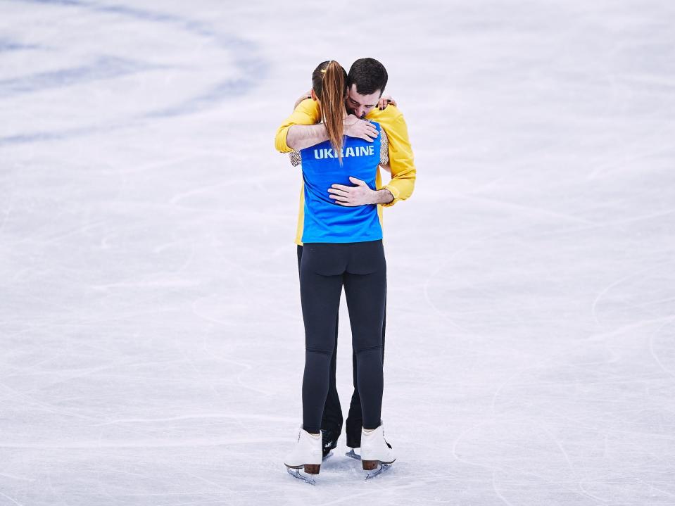 Ukraine's Oleksandra Nazarova and Maksym Nikitin hold each other and cry after completing their performance at World Championships.