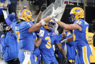 Pittsburgh wide receiver Jordan Addison (3) celebrates with teammates after scoring a touchdown after making a catch during the second half of an NCAA college football game against Virginia, Saturday, Nov. 20, 2021, in Pittsburgh. Pittsburgh won 48-38. (AP Photo/Keith Srakocic)