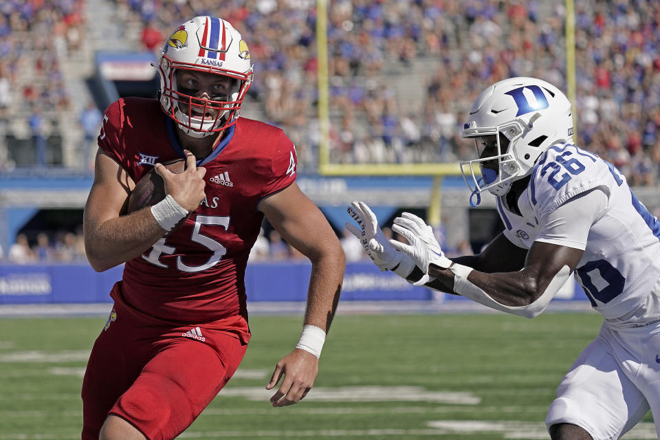 Kansas tight end Trevor Kardell (45) is chased by Duke defensive back Joshua Pickett (26) as he runs for a touchdown during the first half of an NCAA college football game Saturday, Sept. 24, 2022, in Lawrence, Kan. (AP Photo/Charlie Riedel)