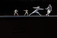 <p>Vladislav Mylnikov of Team ROC and Gerek Meinhardt of Team United States compete in the foreground as Daniele Garozzo of Team Italy and Mohmed Hassan of Team Egypt compete in the background in Men's Foil Individual second round on day three of the Tokyo 2020 Olympic Games at Makuhari Messe on July 26, 2021 in Chiba, Japan. (Photo by Julian Finney/Getty Images)</p> 