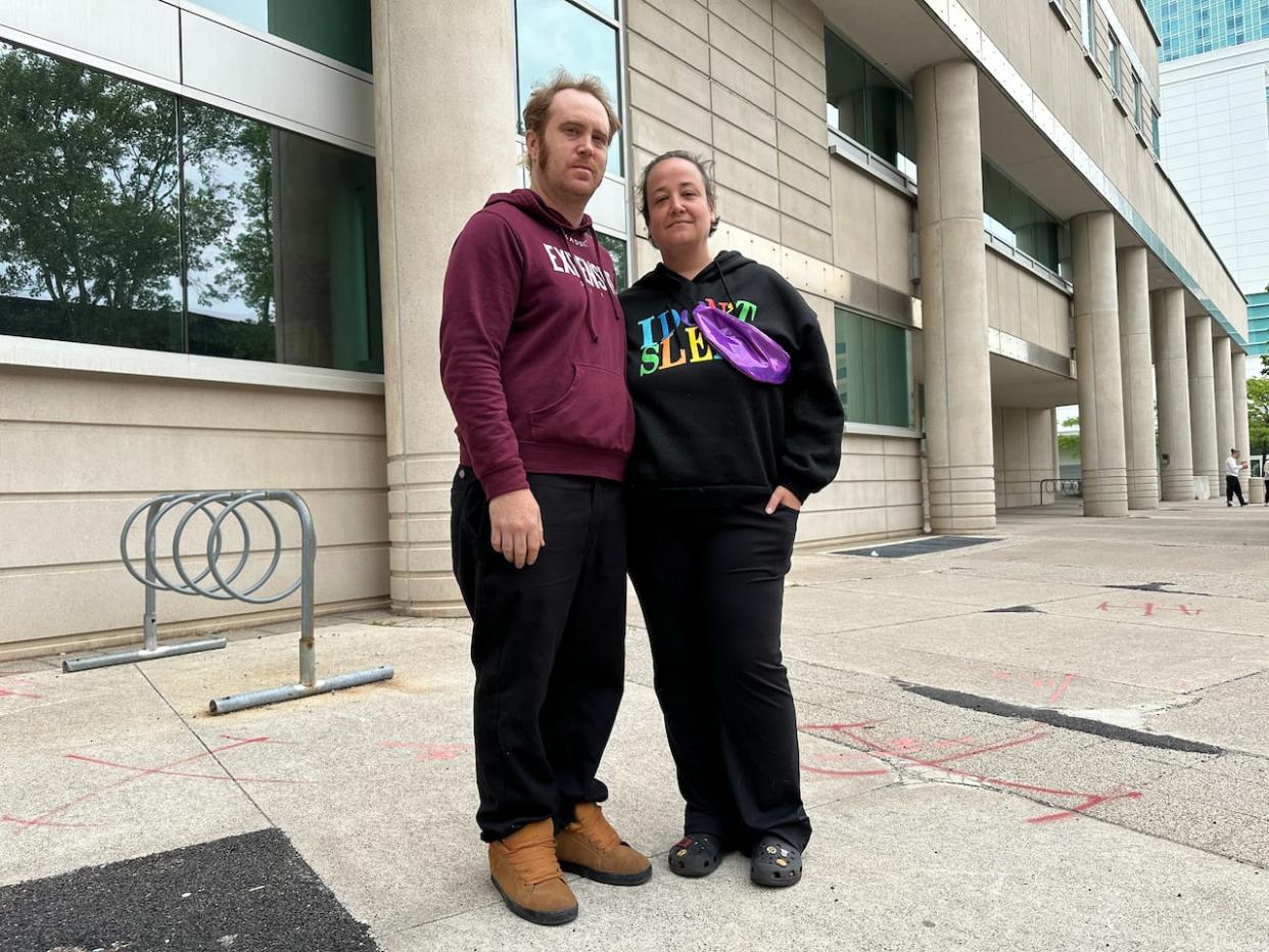 2SLGBTQ+ activist Britt Leroux, right, stands with her husband John Reh outside the Ontario Court of Justice in Windsor on May 15. (Dalson Chen/CBC - image credit)