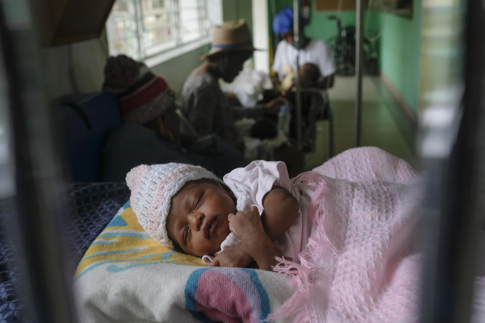 A baby rests on a bed at the Saint Damien Pediatric Hospital of Port-au-Prince, Haiti, Sunday, Oct. 24, 2021. Haiti's capital has been brought to the brink of exhaustion by fuel shortages and the capital's main pediatrics hospital says it has only three days of fuel left to run ventilators and medical equipment. (AP Photo/Matias Delacroix)