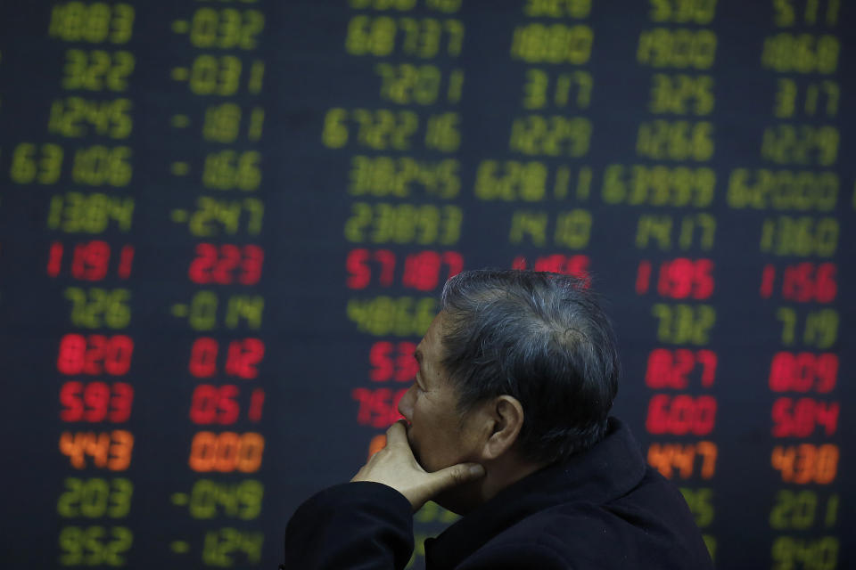 An investor monitors stock prices at a brokerage house in Beijing, Wednesday, Oct. 24, 2018. Asian markets are mixed on Wednesday after U.S. companies, including those that outperformed in the third quarter, cautioned against escalating a trade dispute with China. (AP Photo/Andy Wong)