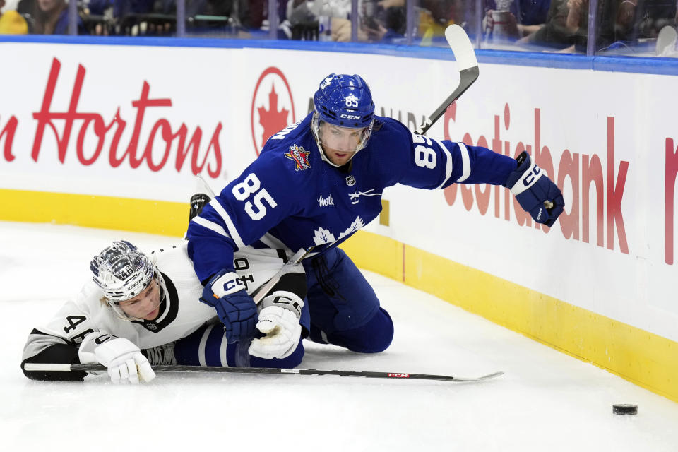 Toronto Maple Leafs' William Lagesson and Los Angeles Kings' Blake Lizotte battle for the puck during the first period of an NHL hockey game, Tuesday, Oct. 31, 2023 in Toronto. (Chris Young/The Canadian Press)