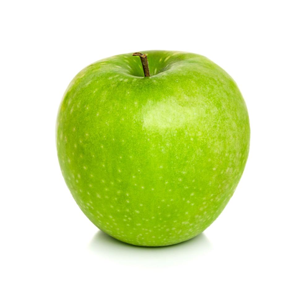 close up of green apple against white background
