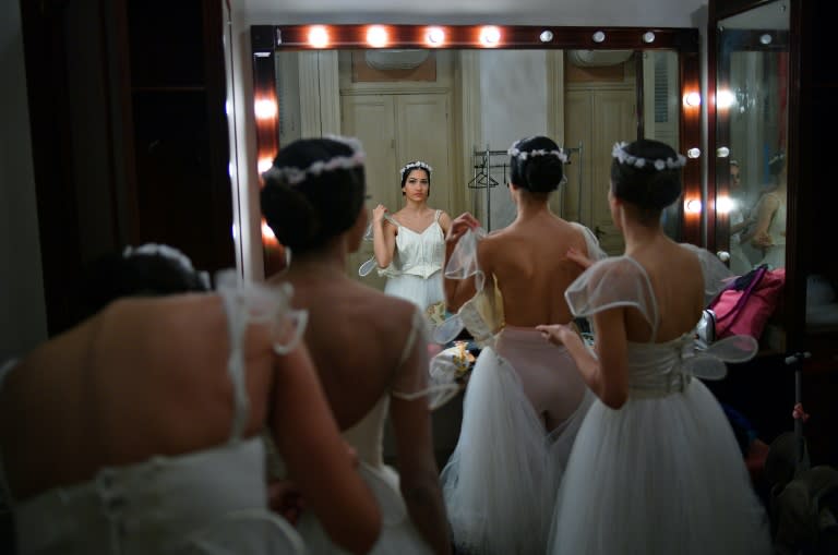 Ballet dancers get ready backstage before performing a ballet production at the Municipal Theater in Rio de Janeiro, Brazil on June 26, 2018