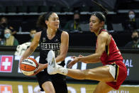 Seattle Storm's Sue Bird, left, looks for room to pass around Las Vegas Aces' Dearica Hamby in the second half of a WNBA basketball game Saturday, May 15, 2021, in Everett, Wash. (AP Photo/Elaine Thompson)