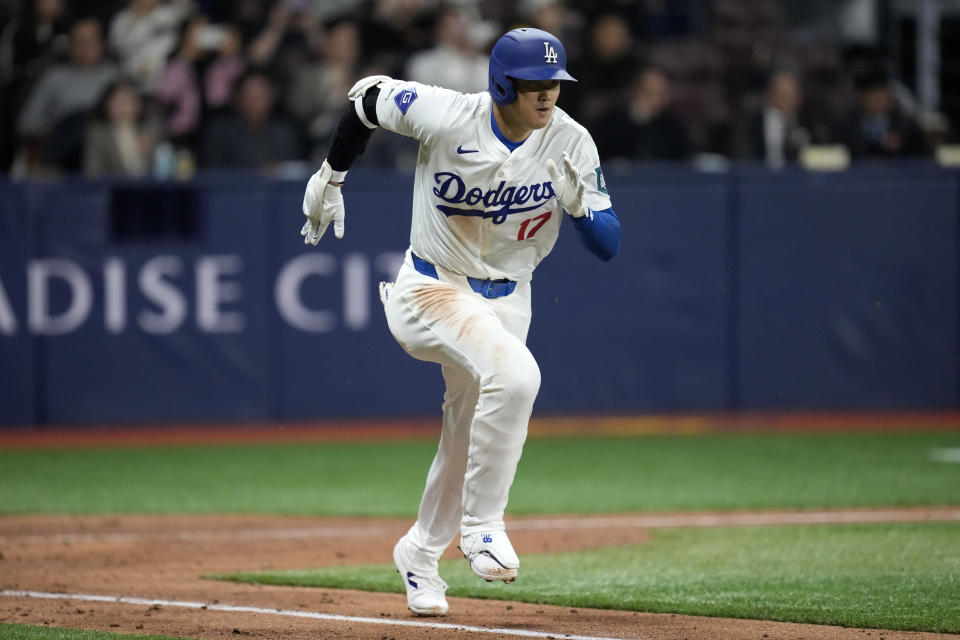 Los Angeles Dodgers designated hitter Shohei Ohtani runs to first as he lines out during the fifth inning of a baseball game against the San Diego Padres at the Gocheok Sky Dome in Seoul, South Korea Thursday, March 21, 2024, in Seoul, South Korea. (AP Photo/Lee Jin-man)