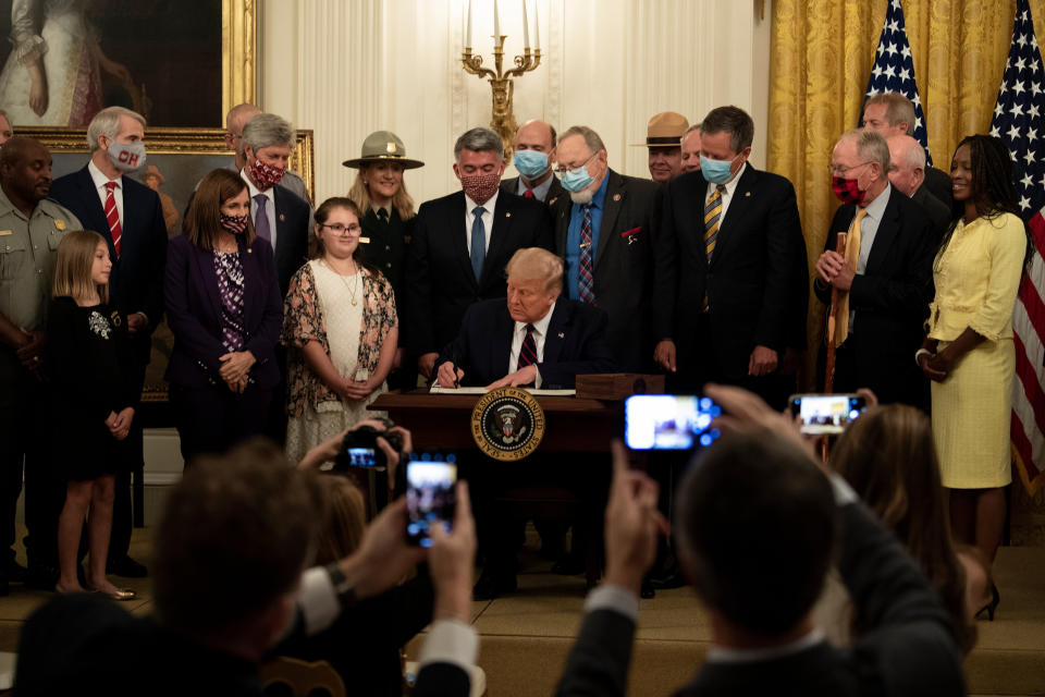 President Donald Trump signs the the Great American Outdoors Act at the White House on Aug. 4. The public lands law aims to fix crumbling national park infrastructure and permanently fund The Land and Water Conservation Fund.  (Photo: BRENDAN SMIALOWSKI via Getty Images)