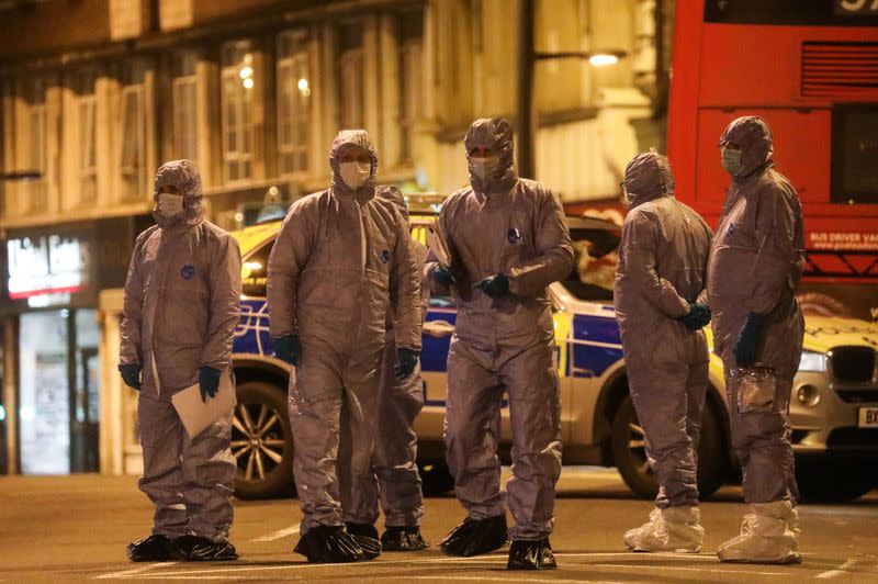 Police forensics officers are seen near a site where a man was shot by armed officers in Streatham, south London