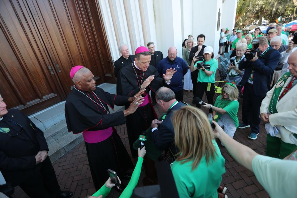 Bishop Stephen Parkes and Most Rev. Jaques Fabre-Jeune bless Grand Marshal John Forbes during the annual Savannah St. Patrick's Day Parade on Saturday, March 16, 2024.