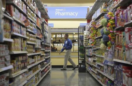 FILE PHOTO - A worker walks past the pharmacy in a new Walmart Express store in Chicago July 26, 2011. REUTERS/John Gress