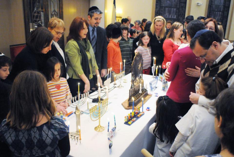 Members of a Reform congregation in Pennsylvania gather for a menorah-lighting ceremony during Hanukkah. <a href="https://www.gettyimages.com/detail/news-photo/wyomissing-pamembers-of-the-congregation-during-the-menorah-news-photo/1315680463?adppopup=true" rel="nofollow noopener" target="_blank" data-ylk="slk:Ben Hasty/MediaNews Group/Reading Eagle via Getty Images;elm:context_link;itc:0;sec:content-canvas" class="link ">Ben Hasty/MediaNews Group/Reading Eagle via Getty Images</a>