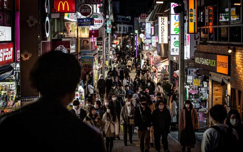 People wearing face masks walk along the Takeshita shopping street  - Yuichi Yamazaki /Getty Images AsiaPac 