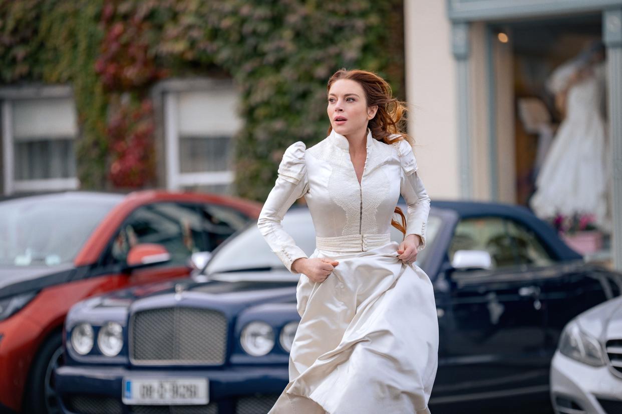A white-gowned Lindsay Lohan trotting in 