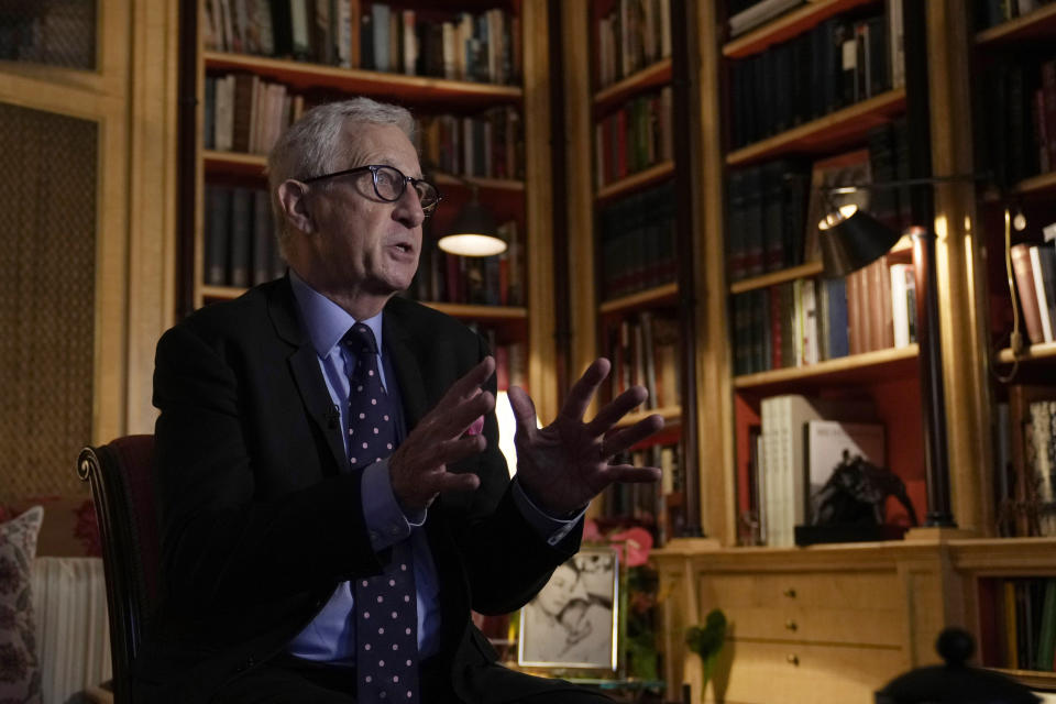 Britain Historian Robert Lacey speaks to The Associated Press at his London home, Friday, Feb. 4, 2022. Britain is getting ready for a party featuring mounted troops, solemn prayers and a pack of dancing mechanical corgis. The nation will celebrate Queen Elizabeth II’s 70 years on the throne this week with four days of pomp and pageantry in central London. (AP Photo/Alastair Grant)