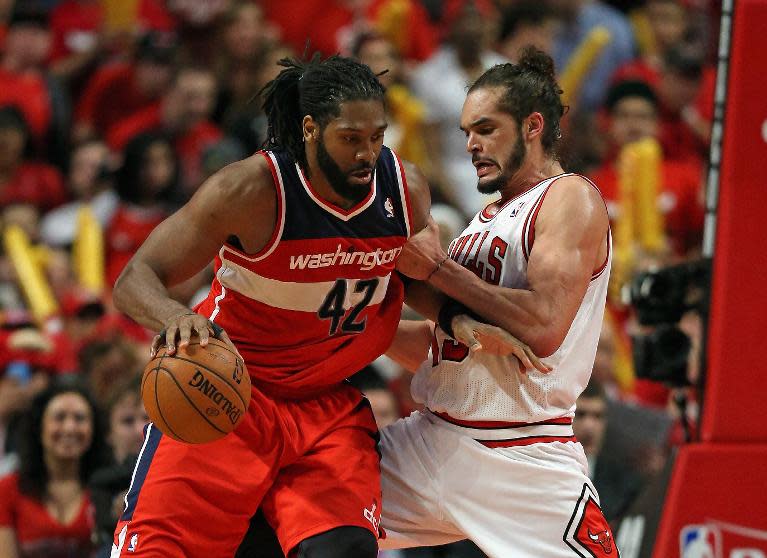 Nene (L) of the Washington Wizards moves past Joakim Noah of the Chicago Bulls in Game 1 of their Eastern Conference quarter-finals during the 2014 NBA Playoffs, at the United Center in Chicago, Illinois, on April 20, 2014