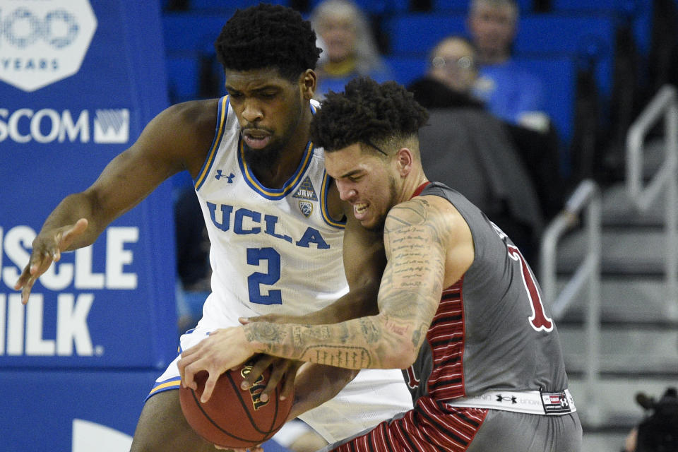UCLA forward Cody Riley, left, steals the ball from Utah forward Timmy Allen during the first half of an NCAA college basketball game in Los Angeles, Sunday, Feb. 2, 2020. (AP Photo/Kelvin Kuo)