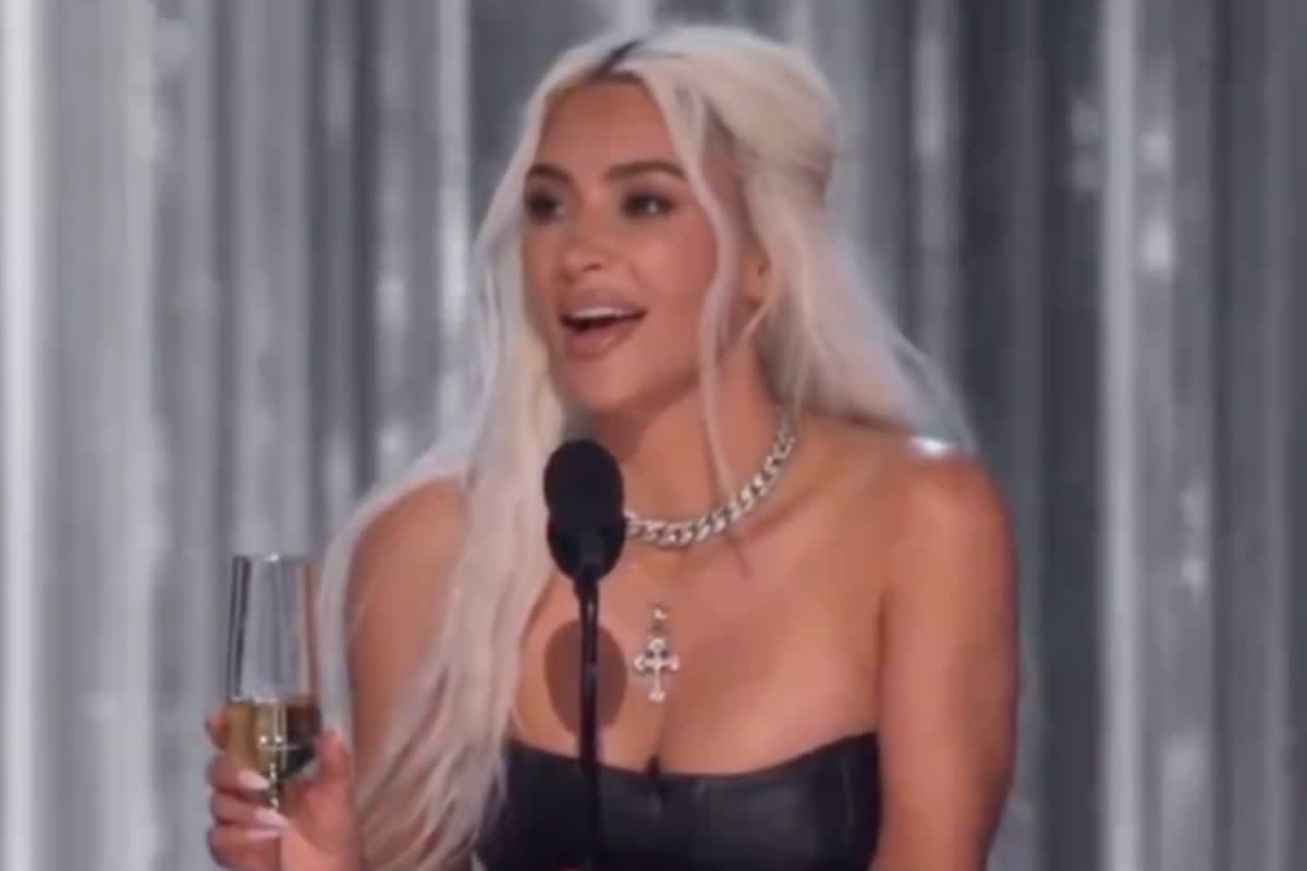 Kim Kardashian on stage at Brady’s roast as the crowd boos her (Netflix)