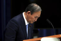 Japan's Prime Minister Yoshihide Suga bows after a press conference at the prime minister's official residence Friday, May 28, 2021, in Tokyo. Japan extended a coronavirus state of emergency in Tokyo and other areas for 20 more days on Friday, with infections still not slowing as it prepares to host the Olympics in just over 50 days. (Behrouz Mehri/Pool Photo via AP)