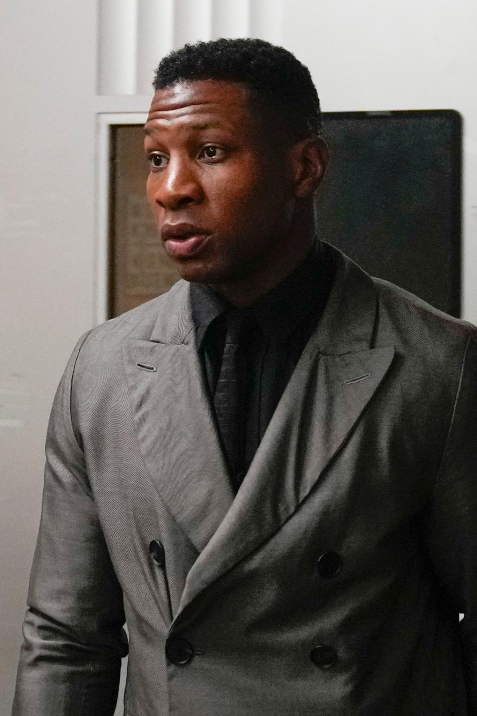 Jonathan Majors leaves a courtroom at the Manhattan criminal courts in New York, Monday, Dec. 18, 2023. The actor is accused of assaulting his then-girlfriend as the two struggled over a phone in the back seat of a chauffeured car. (AP Photo/Seth Wenig)