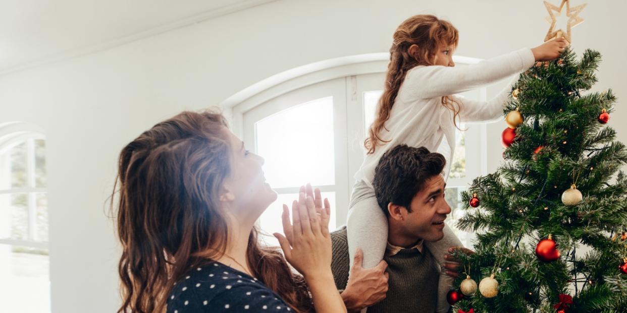 family decorating Christmas tree - neurodivergent daughter