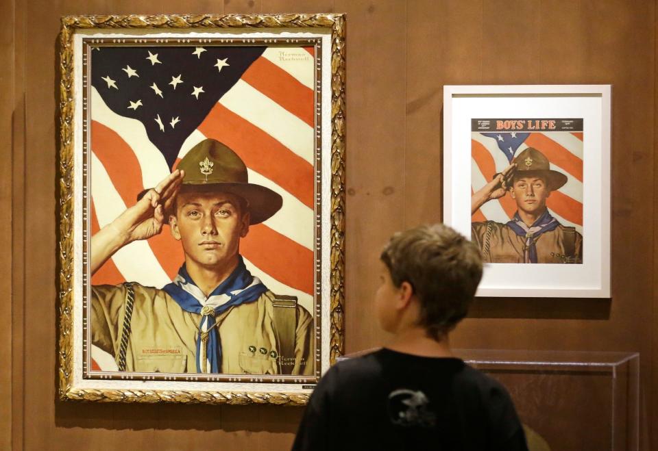 A child looks over a Norman Rockwell exhibit in Salt Lake City. Rockwell started his career creating illustrations for the Boy Scouts’ Hike Book. The Scouts still own about 70 of the famed artist’s works.