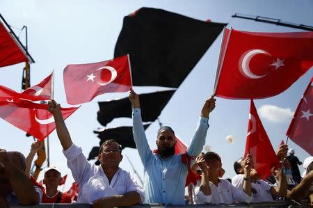 People wave Turkey's national flags ahead of the Democracy and Martyrs Rally, organized by Turkish President Tayyip Erdogan and supported by ruling AK Party (AKP), oppositions Republican People's Party (CHP) and Nationalist Movement Party (MHP), to protest against last month's failed military coup attempt, in Istanbul, Turkey, August 7, 2016. REUTERS/Osman Orsal