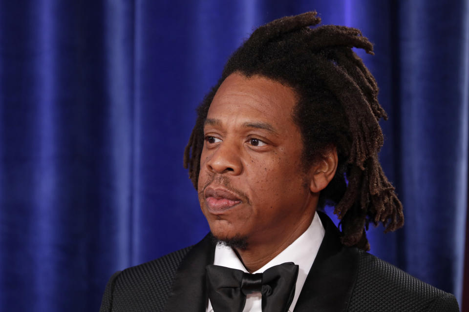 American rapper Jay-Z wearing black suit attending movie premiere.