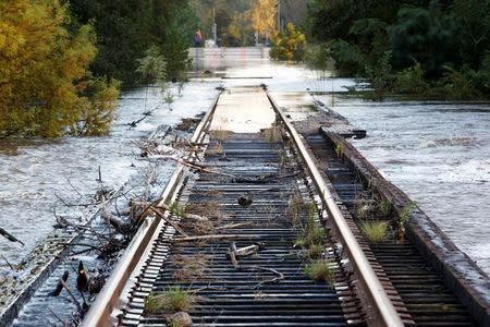 Debris swept downriver by the rising Tar River litter a flooded rail bridge crossing the river from Tarboro into Princeville as the river crests in the aftermath of Hurricane Matthew, in Tarboro, North Carolina on October 13, 2016. REUTERS/Jonathan Drake