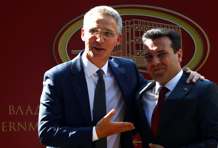 NATO Secretary-General Jens Stoltenberg hugs Macedonia's Prime Minister Zoran Zaev during a news conference in Skopje, Macedonia, September 6, 2018. REUTERS/Ognen Teofilovski