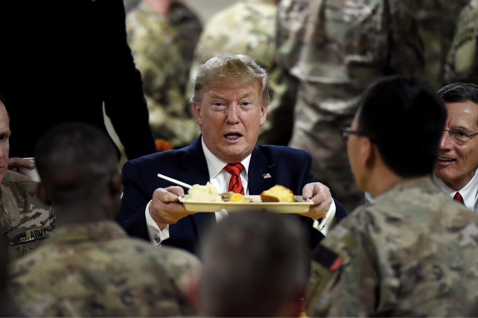 President Donald Trump serves Thanksgiving dinner to U.S. troops at Bagram Air Field during a surprise visit on Nov. 28, 2019, in Afghanistan. 