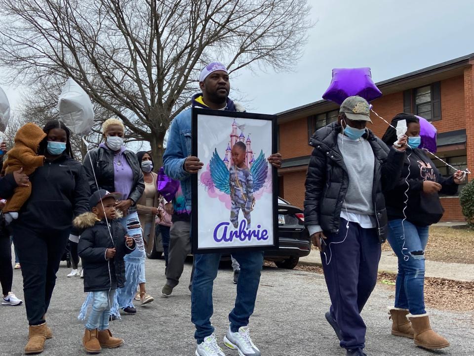 Arthur Anthony carries a picture of his 8-year-old daughter, Arbrie Anthony, who was killed in a drive by shooting. A march was held in her memory Saturday, January 15, 2022.