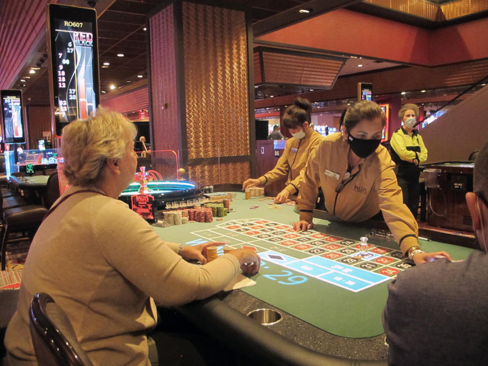 This June 23, 2021 photo shows people playing roulette at Bally's casino in Atlantic City N.J. On Oct. 25, 2021, panelists at the East Coast Gaming Congress in Atlantic City pondered what the casino floor of the future should look like, including how to attract the next generation of gamblers. (AP Photo/Wayne Parry)