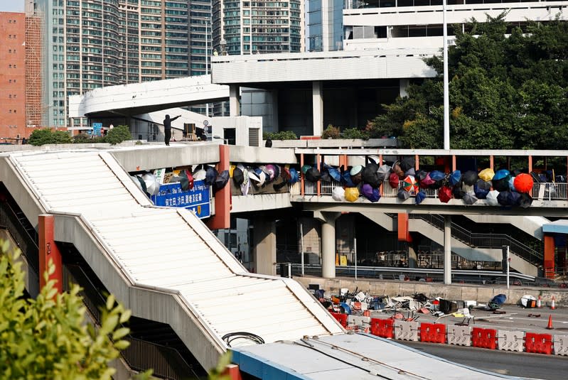 A protester stands on a bridge that runs over the entrance to the Cross Harbour Tunnel in Hong Kong