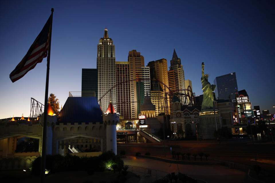 The sun sets along the Las Vegas Strip devoid of the usual crowds and traffic after casinos and other business continue to be shuttered due to the coronavirus Tuesday, April 28, 2020, in Las Vegas. (AP Photo/John Locher)
