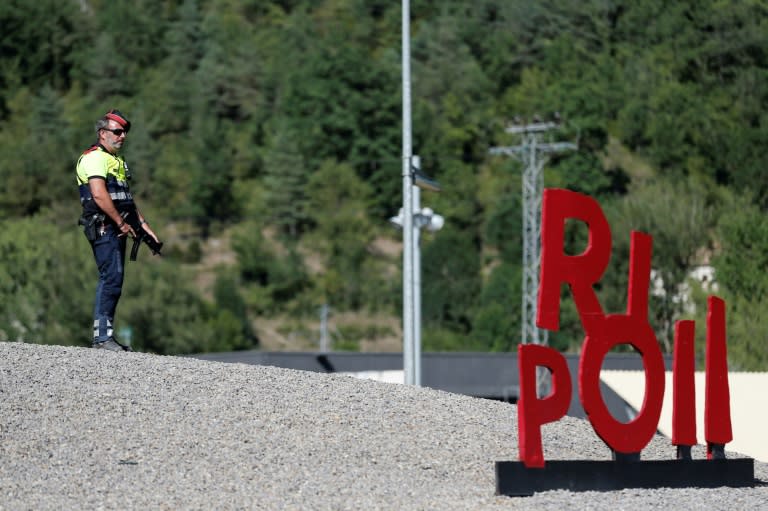 A Police officer stands guard at a blocked road near Ripoll after last year's attack