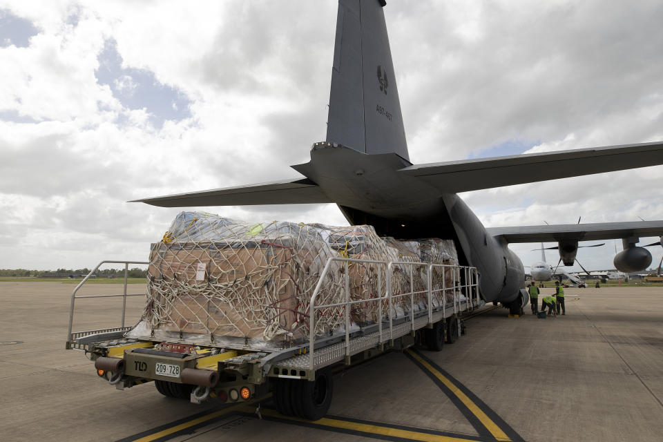 In this photo provided by the Australian Defense Force, a C-130J Hercules aircraft is loaded with humanitarian assistance and supplies at RAAF Base Amberley, Australia, Friday, Jan. 21, 2022, bound for Tonga after a volcanic eruption. New Zealand and Australia each have sent military transport planes that were carrying water containers, kits for temporary shelters, generators, hygiene supplies and communications equipment. (LACW Kate Czerny/Australian Defense Force via AP)