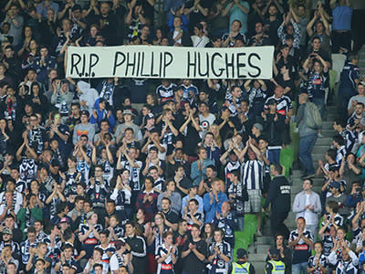 The crowd broke into applause during the 63rd minute in tribute to Phillip Hughes, unveiling this banner.