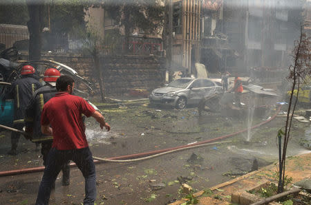 Firefighters try to put out a fire after rockets fired by insurgents hit the al-Dabit maternity clinic in government-held parts of Aleppo city, Syria, in this handout picture provided by SANA on May 3, 2016. SANA/Handout via REUTERS