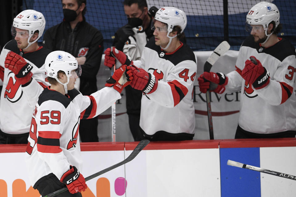 New Jersey Devils left wing Janne Kuokkanen (59) is congratulated for his goal during the second period of the team's NHL hockey game against the Washington Capitals, Tuesday, March 9, 2021, in Washington. (AP Photo/Nick Wass)