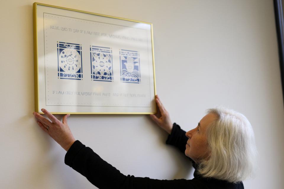 Harvard Law professor Martha Minow adjusts a framed image, with words by the rabbi known as Hillel the Elder, in her Cambridge, Mass., office at Harvard Law School on Thursday, May 4, 2023. | Alyssa Stone, for the Deseret News