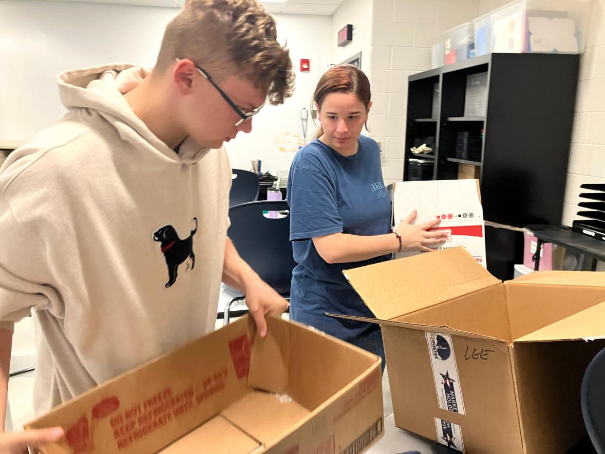 Kevin Miller and Mikaela Mason help organize Liz Keller's Staunton High School classroom Wednesday, Aug. 2. They were part of the Youth Volunteer Corps that helped teachers get their classrooms ready for the start of school.