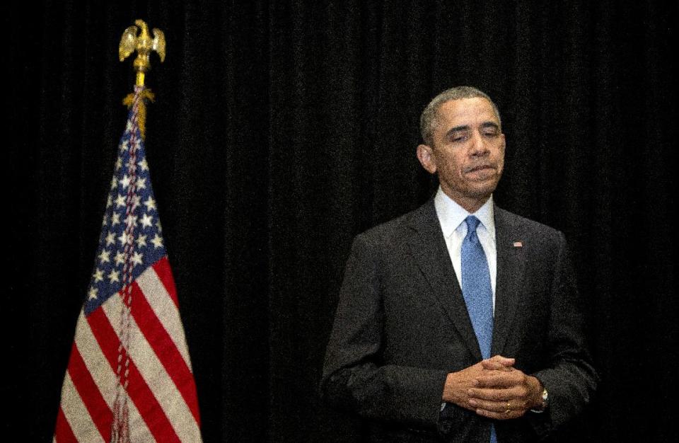 President Barack Obama pauses as he speaks about the shooting at Fort Hood, Wednesday, April 2, 2014, in Chicago. (AP Photo/Carolyn Kaster)