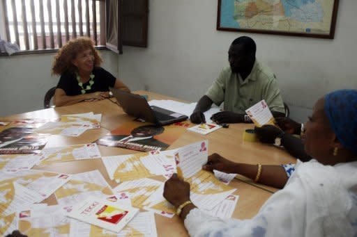 French-born Senegalese candidate Laurence Gavron (L), running for the TEKKI party in upcoming legislative elections speaks with fellow candidates El Hadji Sarr (C) and Aissatou Thiam at the party's headquarters in Dakar. Senegal voted for a new parliament with President Macky Sall seeking a majority to put his policies into action after ousting the veteran former leader Abdoulaye Wade in March