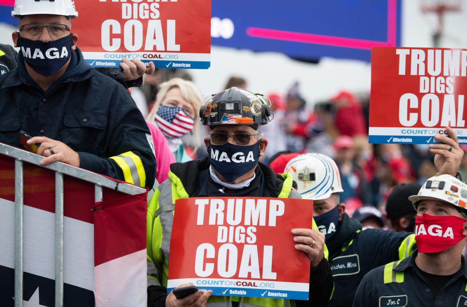 Supporters holds signs in favor of coal mining as US President Donald Trump speaks during a Make America Great Again campaign rally at Altoona-Blair County Airport in Martinsburg, Pennsylvania, October 26, 2020. (Photo by SAUL LOEB / AFP) (Photo by SAUL LOEB/AFP via Getty Images)